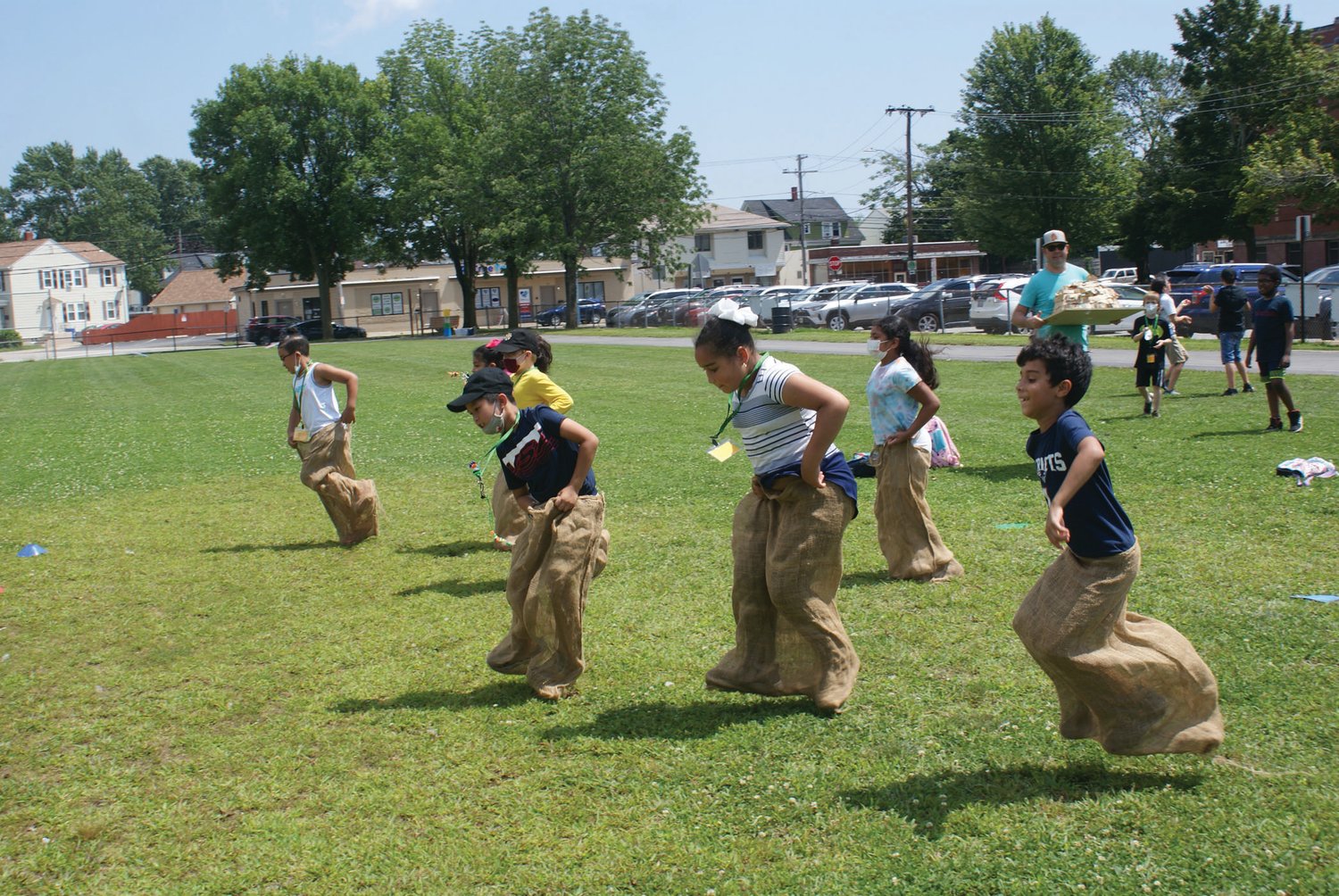 A HOP AWAY: Students celebrated the completion of Camp XL at Bain Middle School, enjoying activities such as sack races. 
